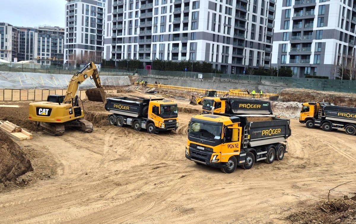 Proger tipper trucks and excavator on an urban civil works site